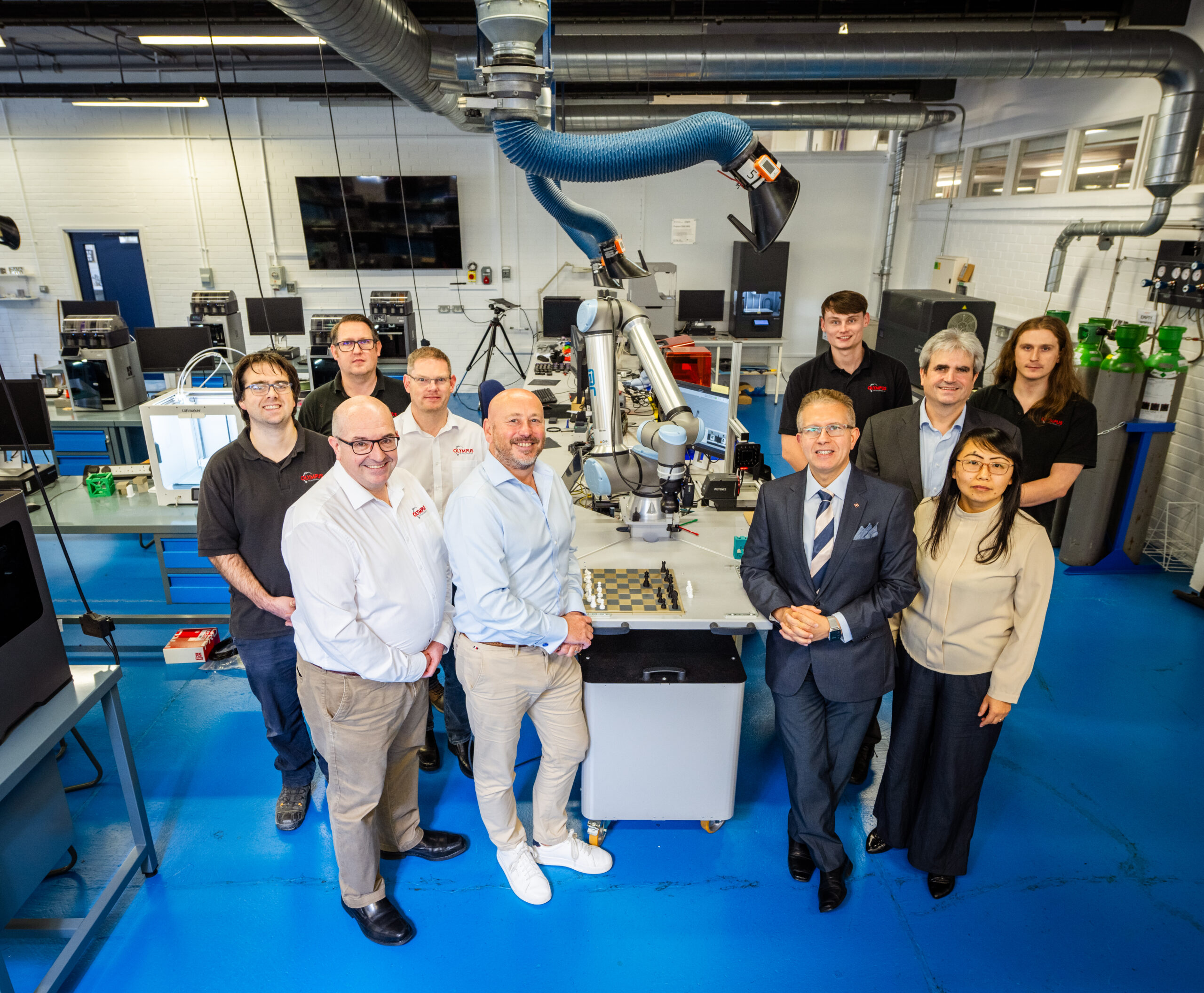 Olympus Technologies and partner teams standing in front of a robot for the Yorkshire Robotics Adoption Hub announcement.